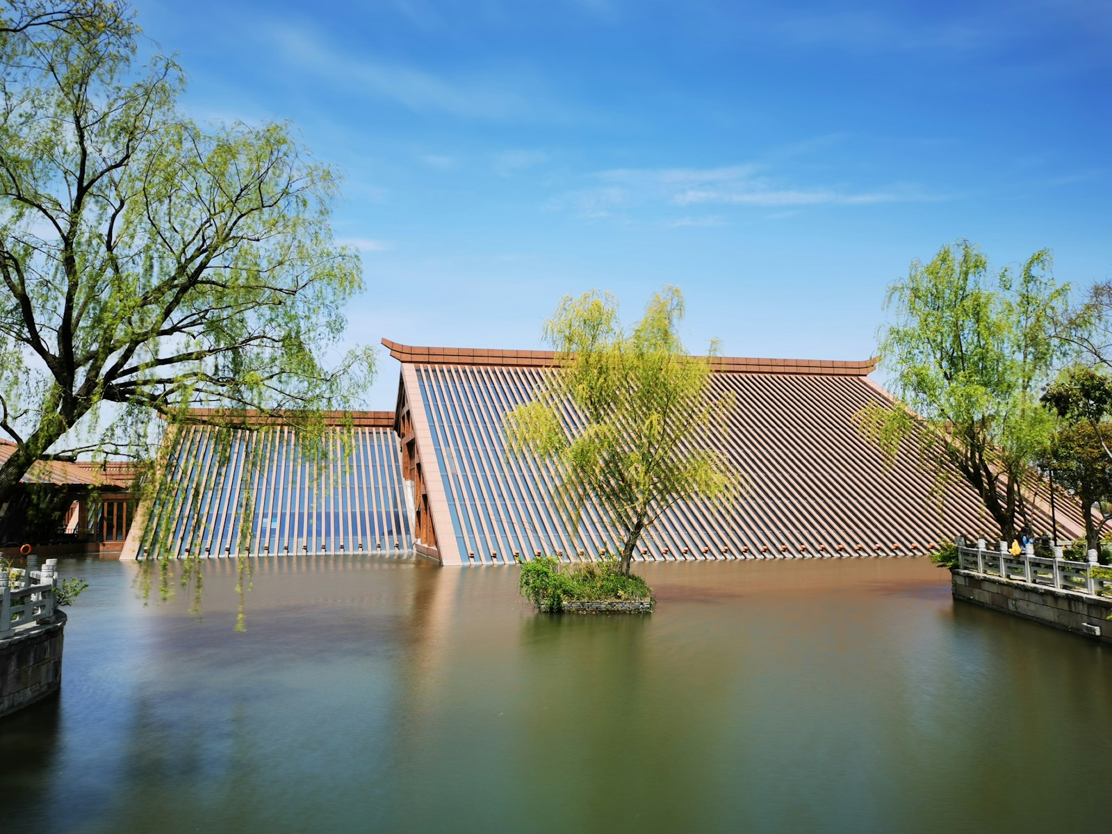 brown wooden fence near green trees and river during daytime